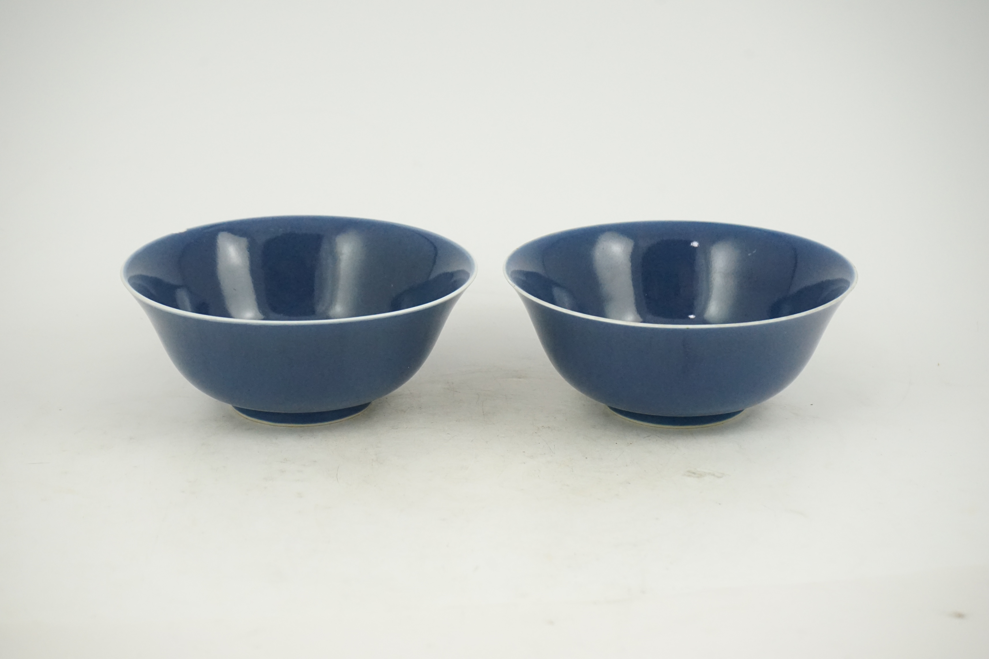 A pair of Chinese powder blue glazed bowls, Daoguang mark and of the period (1821-50)